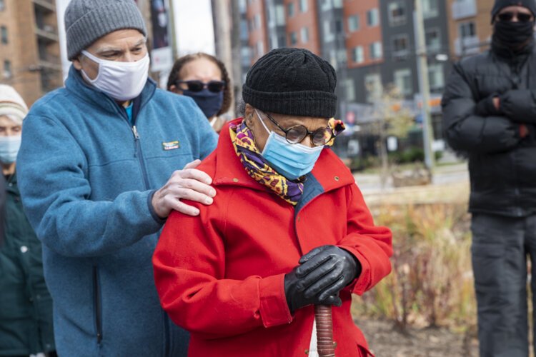 Joan Evelyn Southgate looks down at her plaque during the dedication at the Cozad Bates House.